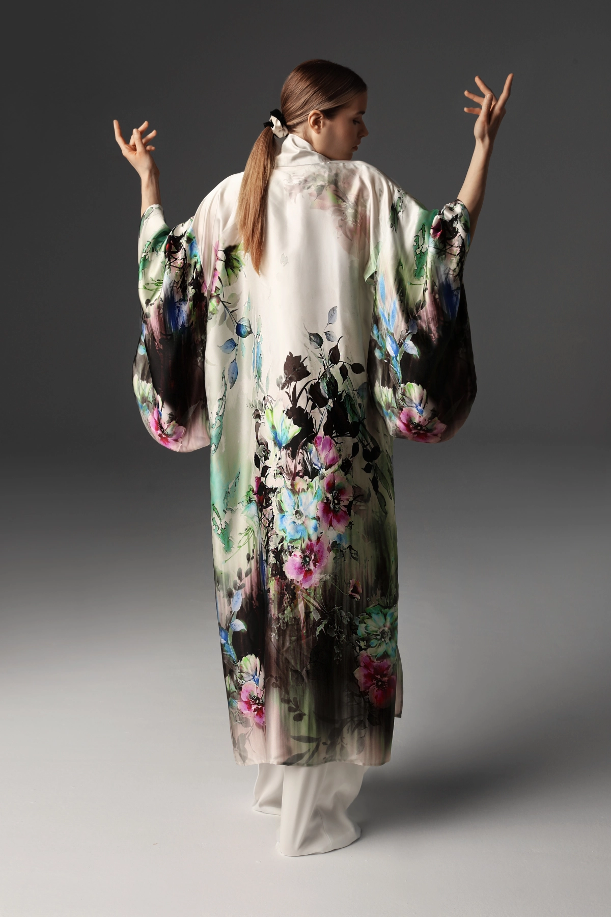 Widok modelki z tyłu prezentującej jedwabne kimono Monika Adamska ukazujące kwiatowy wzór.