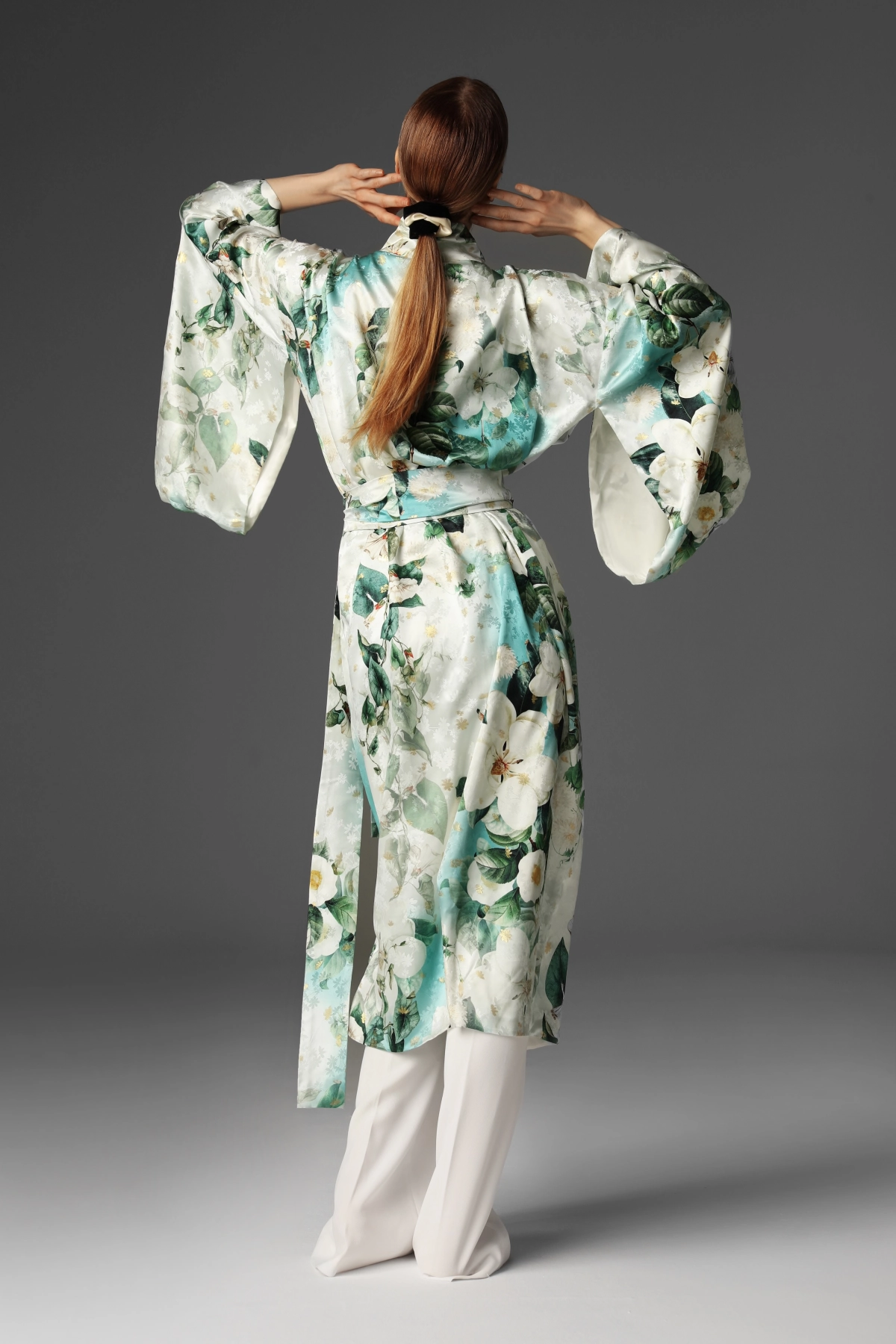 Modelka prezentująca zawiązane kimono z tyłu z widocznym elementem furi (niezszyta część rękawa).