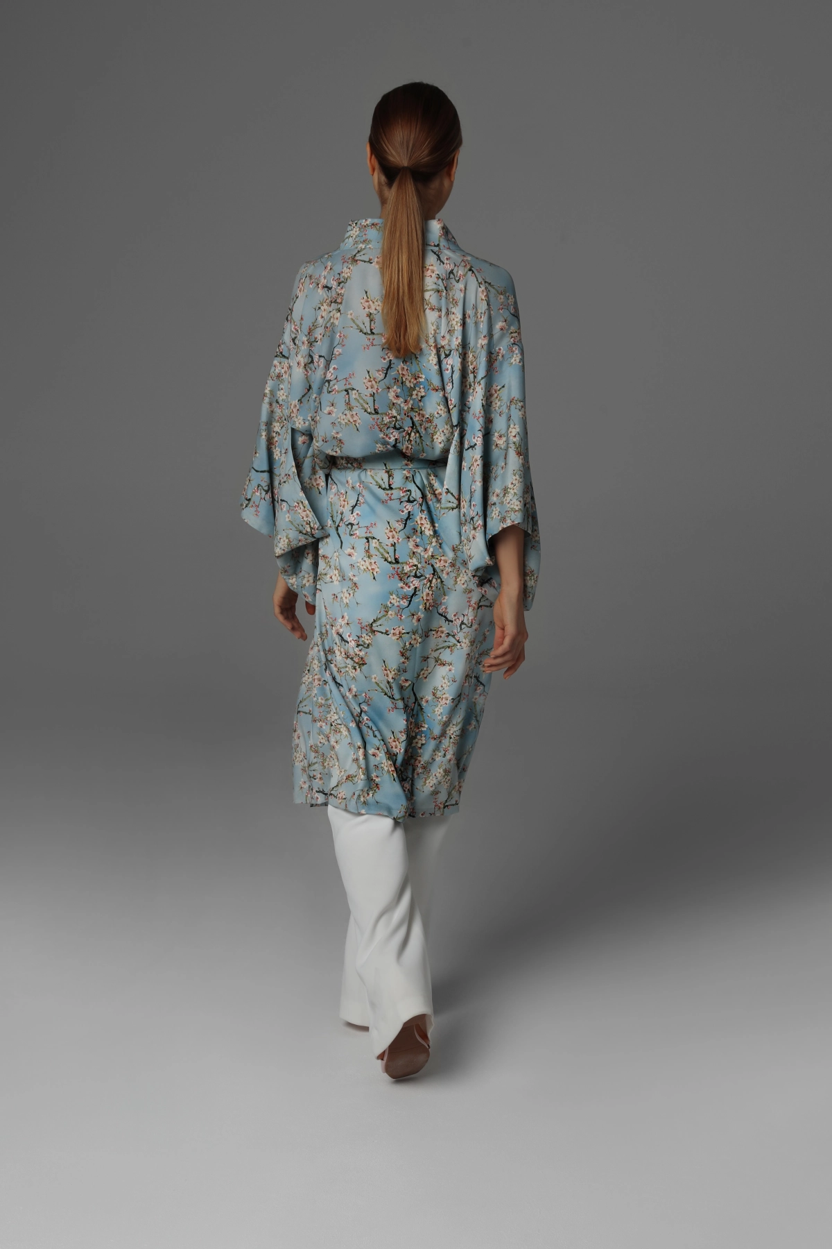 Model presenting the back of a long silk kimono, Monika Adamska.