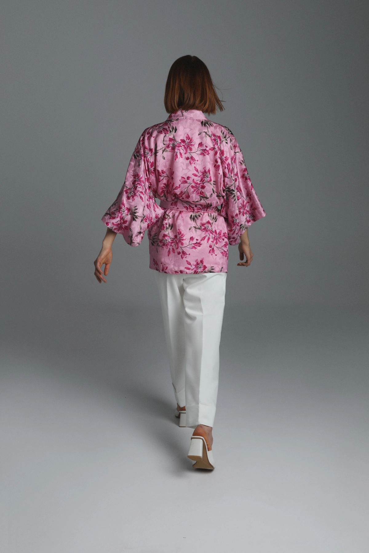 Model presenting the rear view of a short silk kimono by Monika Adamska.