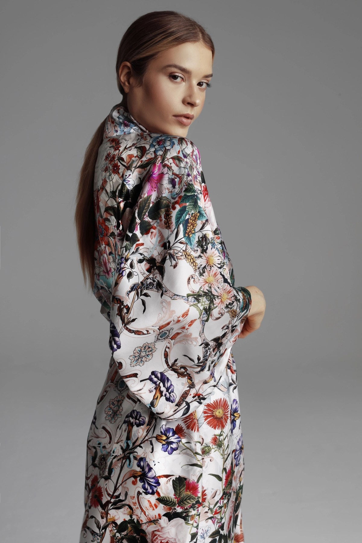 A close-up photograph of a kimono sleeve and a floral summer pattern.