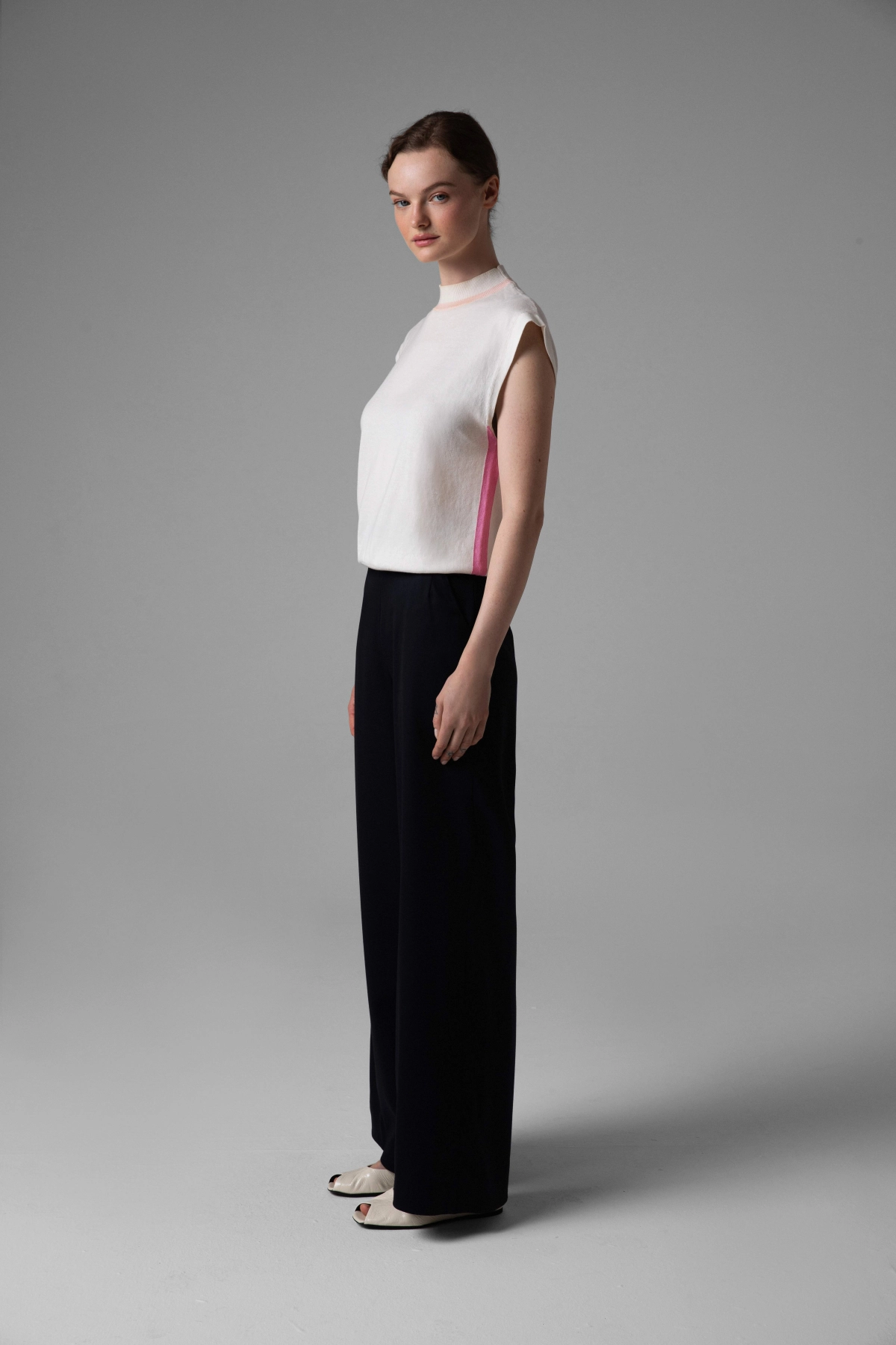 Navy wool trousers Monika Adamska, wide legs, high waist, model in side view