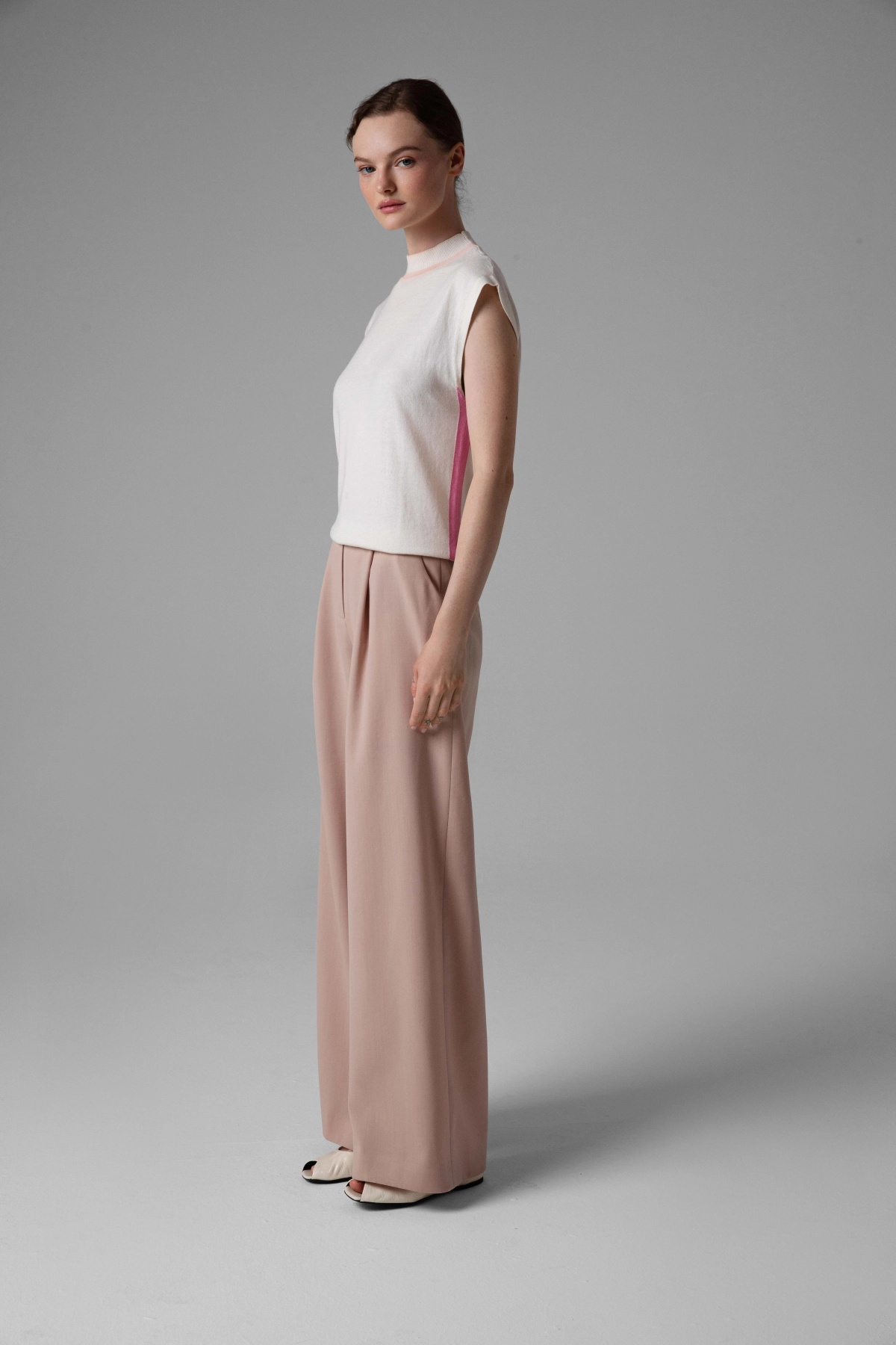 Beige wool trousers Monika Adamska, wide legs, front pleats, model side view