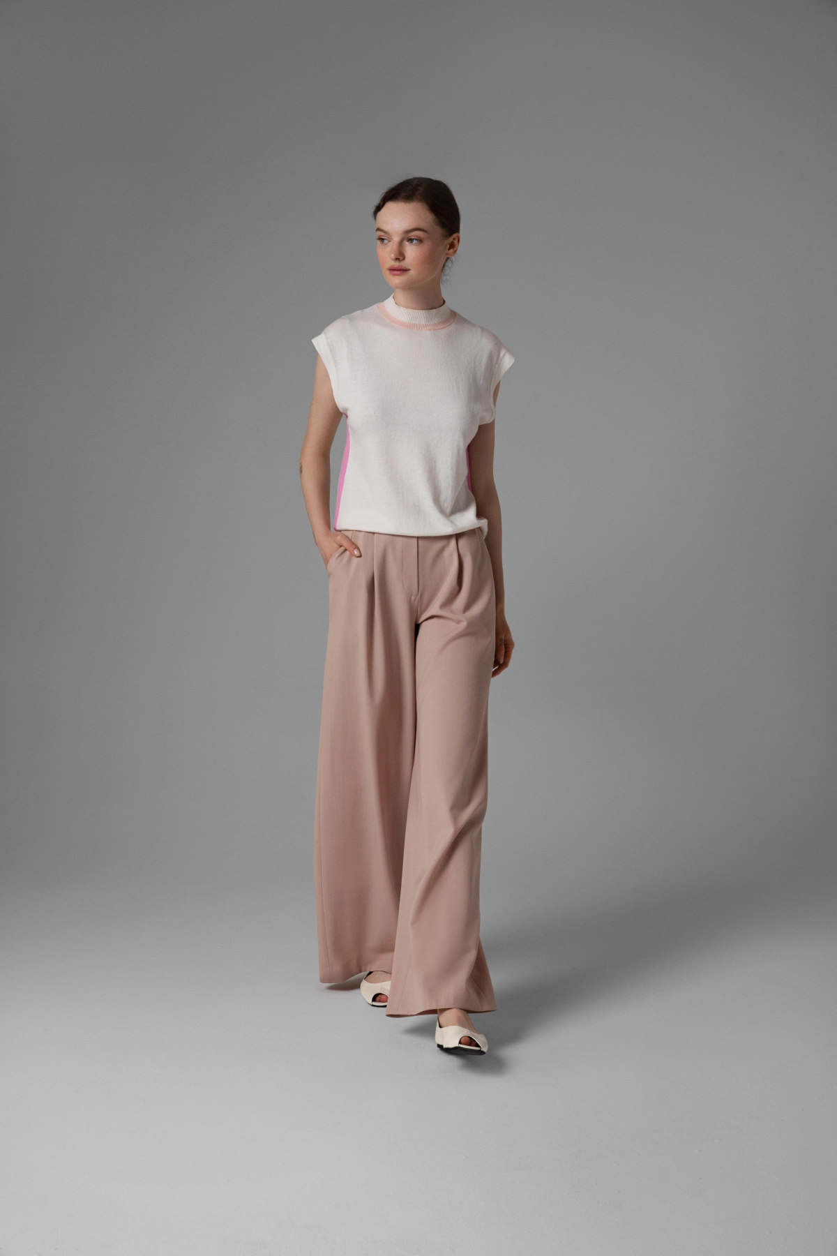 Monika Adamska beige wool trousers, wide legs, front pleats, model front view