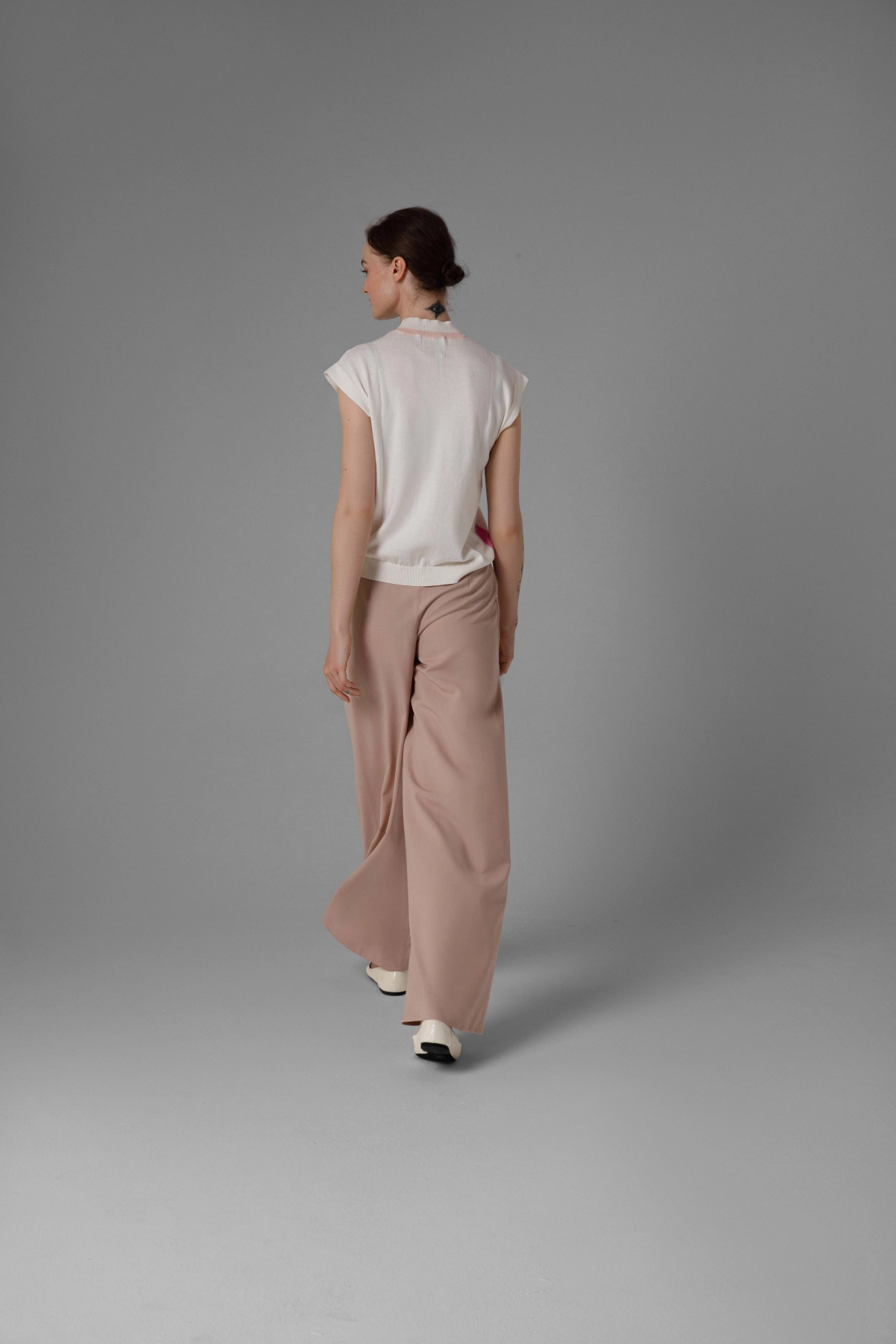 Monika Adamska beige wool trousers, wide legs, front pleats, model back view
