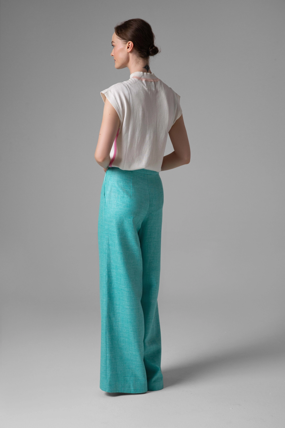 Turquoise noble fabric trousers Monika Adamska, wide legs, side view on model