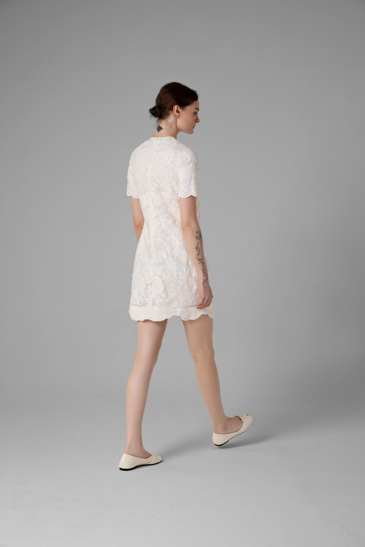 Black dress with floral embroidery, close-up of neckline and sleeve details