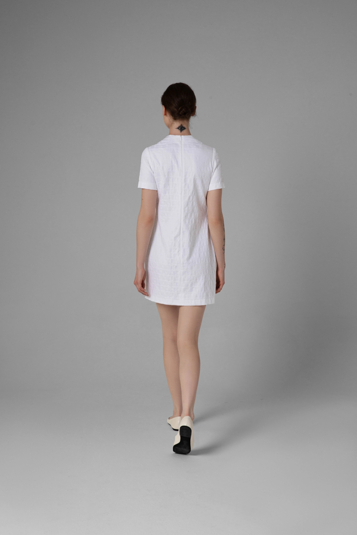 White jacquard dress, back view, subtle floral fabric texture