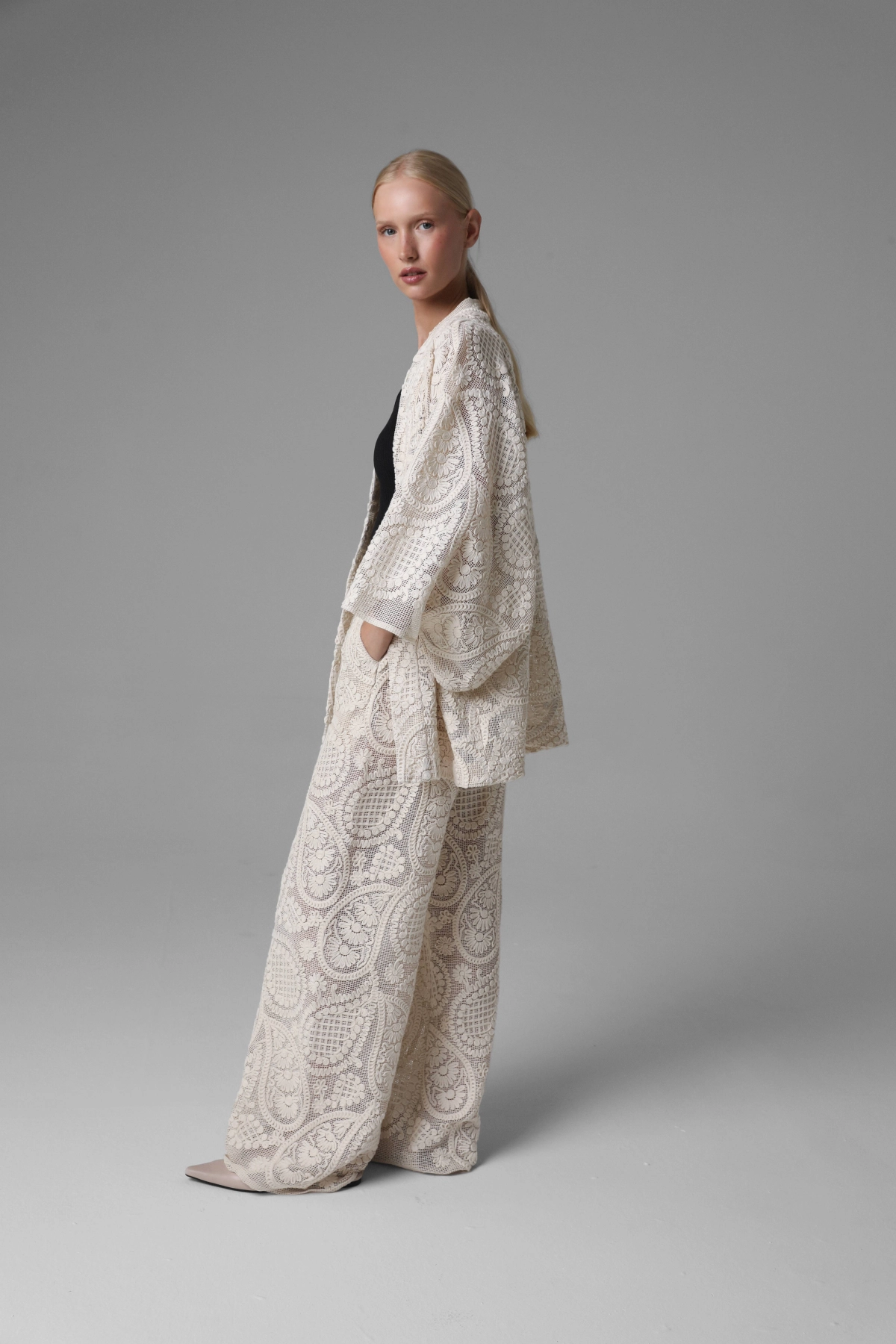Short crochet look kimono with paisley motif, side view on model