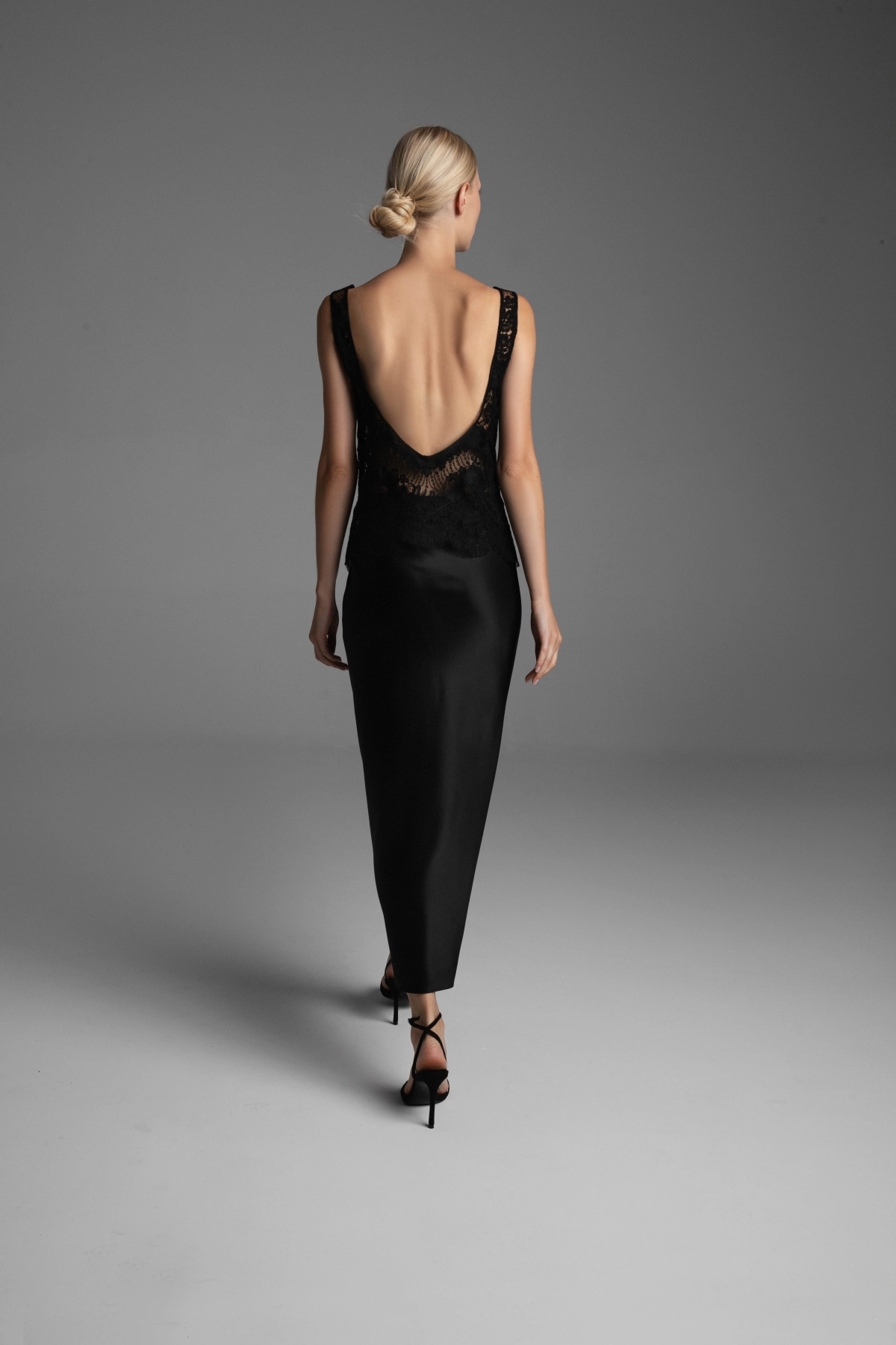 Model showing the back of a blouse and skirt made from bias-cut fabric.