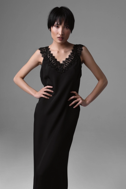 Front view of Monika Adamska black silk evening dress with deep beaded French lace neckline and couture finish