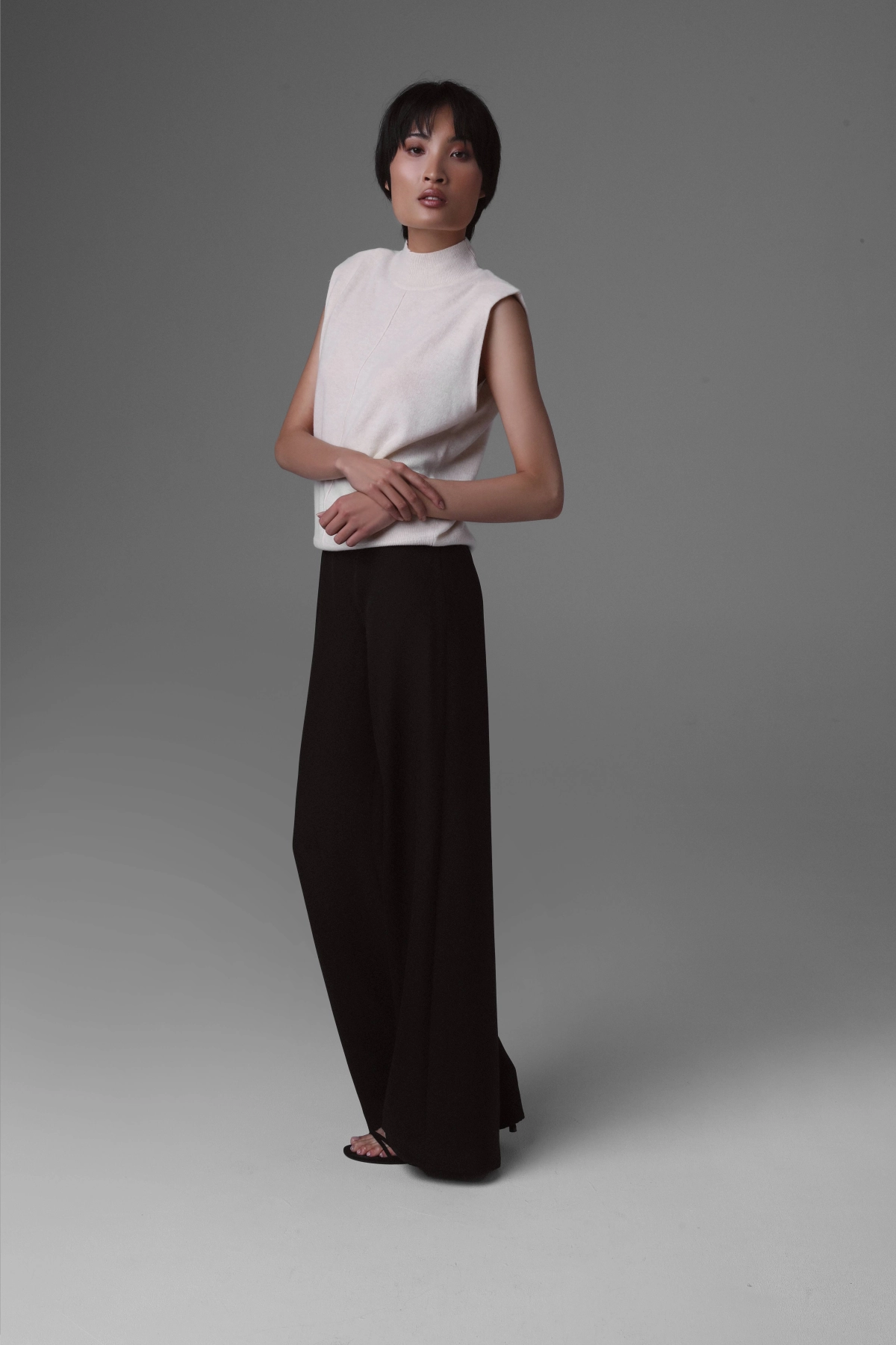 Black high-waisted wide-leg trousers in silk crepe.