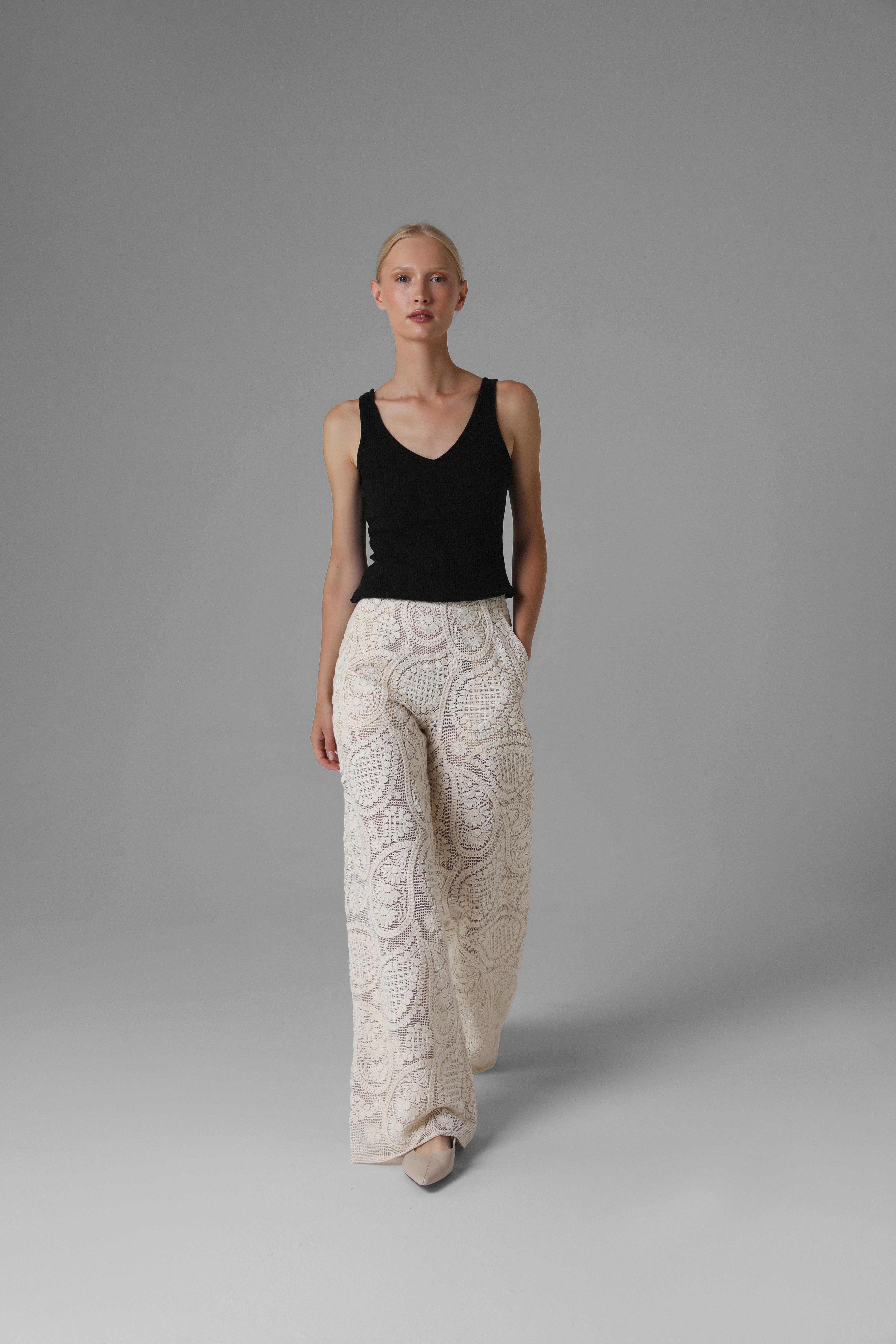 Model shows Monika Adamska embroidered cotton trousers, wide legs, movement in frame